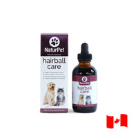 NaturPet Hairball Care for cats and dogs, 100 mL liquid herbal supplement in an amber bottle beside retail box with Canadian flag.